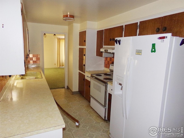 kitchen featuring white appliances, ventilation hood, light floors, a sink, and light countertops