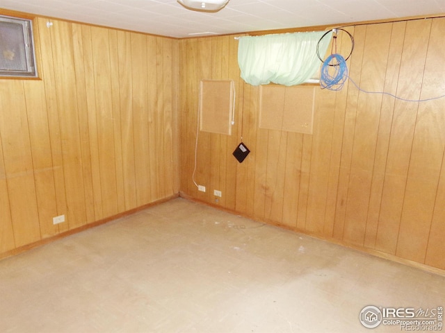 spare room featuring wooden walls