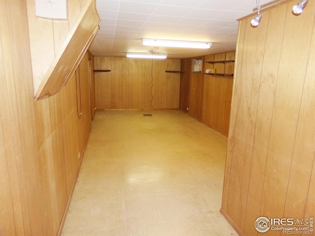 finished basement with light floors and wood walls