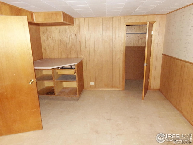 bedroom with wood walls and wainscoting