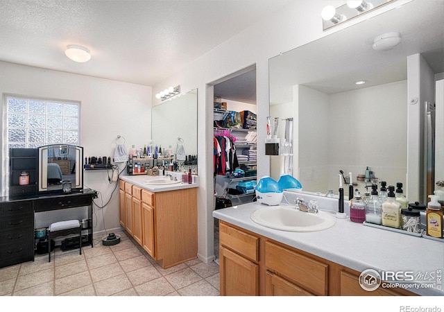 3937 Kenwood Cir, Johnstown, CO 80534 - full bathroom featuring a sink, a textured ceiling, two vanities, and tile patterned floors