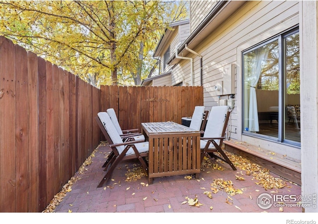 view of patio with outdoor dining area and fence