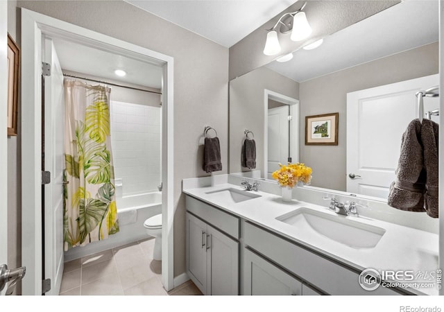 bathroom with a sink, toilet, shower / bathtub combination with curtain, and double vanity