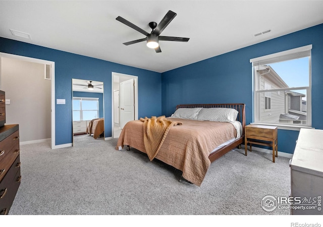 carpeted bedroom featuring baseboards, ceiling fan, and visible vents