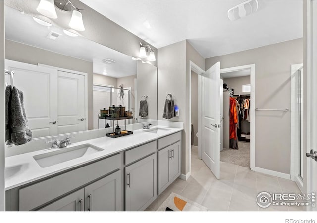 full bath featuring baseboards, a sink, and a stall shower