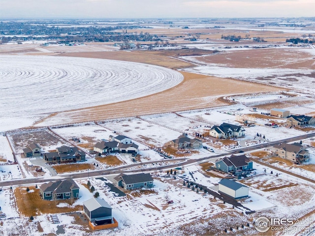 snowy aerial view featuring a residential view