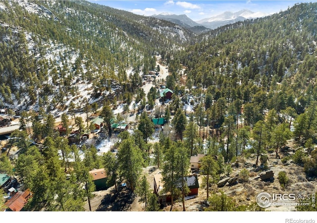 drone / aerial view with a mountain view and a wooded view