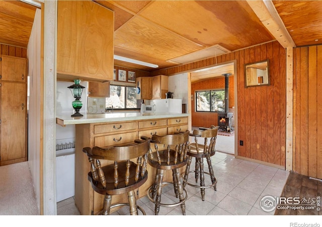 224 Loveland Heights Ln, Drake, CO 80515 - kitchen with a wealth of natural light, wood ceiling, wood walls, and a wood stove