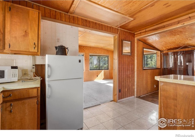 224 Loveland Heights Ln, Drake, CO 80515 - kitchen with white appliances, wooden walls, and a wealth of natural light
