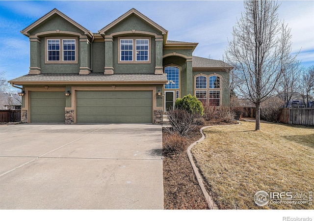 view of front of home with stucco siding, concrete driveway, a garage, and fence