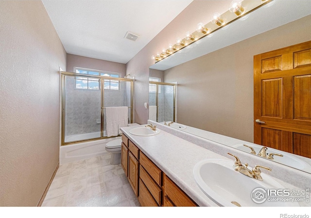 bathroom featuring double vanity, visible vents, and a sink