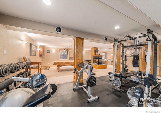 workout area featuring recessed lighting, a multi sided fireplace, pool table, and ornate columns