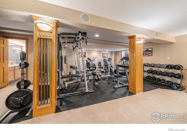 gym featuring recessed lighting and a sink