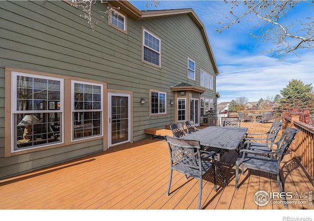 wooden deck featuring outdoor dining area