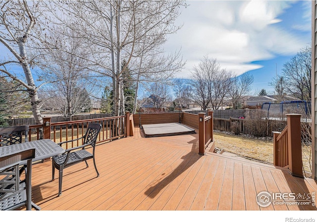 wooden terrace with a fenced backyard