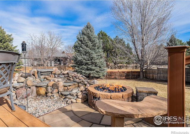 view of patio / terrace featuring fence and an outdoor fire pit