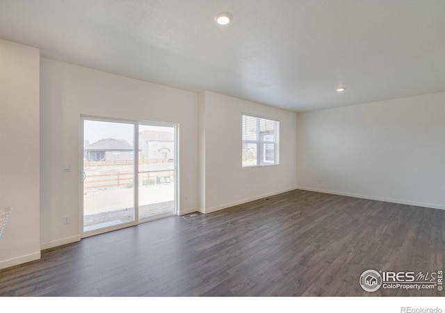 unfurnished room with recessed lighting, baseboards, and dark wood-style flooring