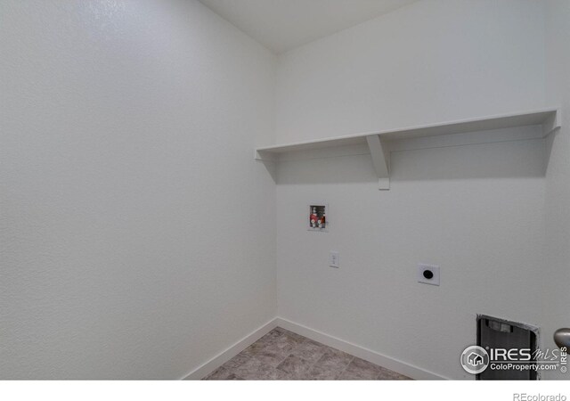 washroom with laundry area, baseboards, and washer hookup