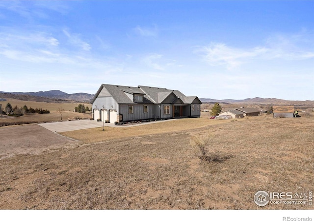 view of front of house featuring a mountain view, a garage, and driveway