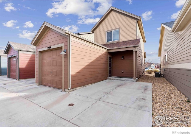 view of front of property with central air condition unit and a garage