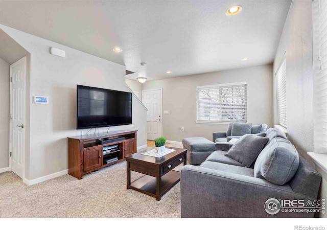 living room featuring light carpet, recessed lighting, and baseboards