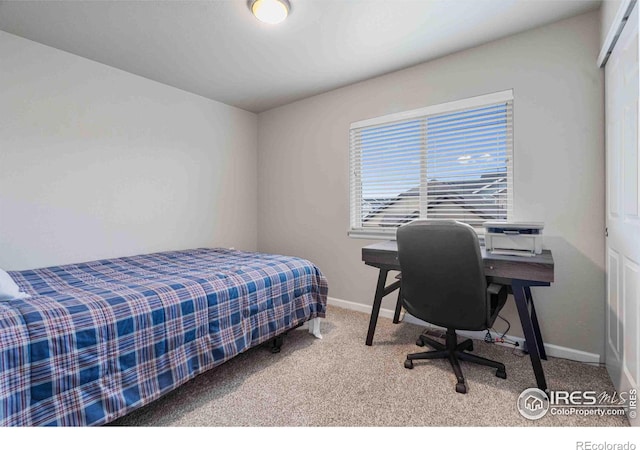 carpeted bedroom with baseboards