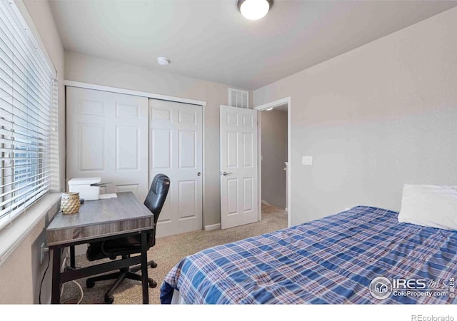 bedroom featuring a closet, visible vents, and carpet floors