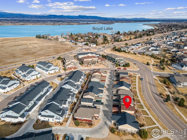 birds eye view of property with a residential view and a water and mountain view