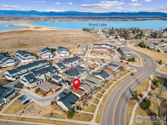 aerial view featuring a residential view and a water and mountain view