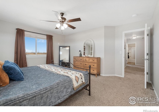 carpeted bedroom with a ceiling fan and baseboards