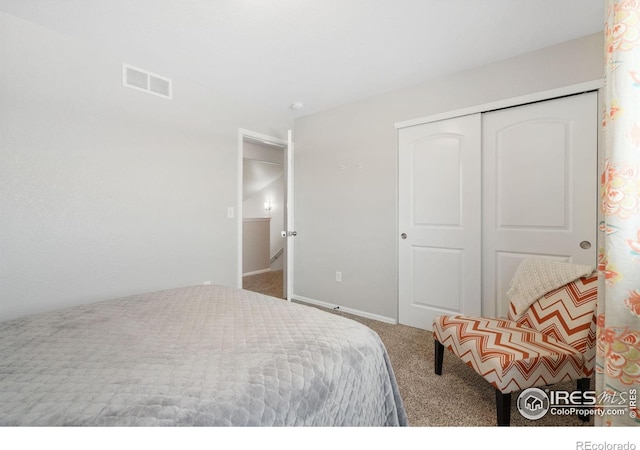 bedroom with baseboards, visible vents, carpet floors, and a closet