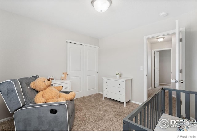 bedroom featuring a closet, light carpet, and baseboards