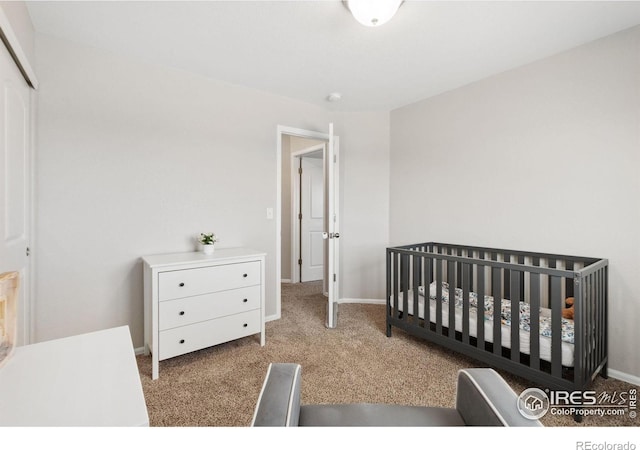 bedroom with a closet, baseboards, and carpet floors