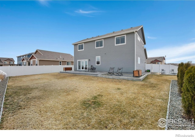 rear view of property with a patio, a fenced backyard, and a lawn