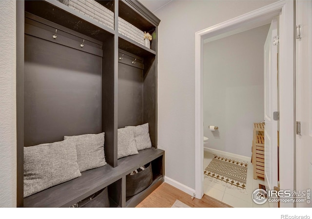 mudroom featuring wood finished floors and baseboards