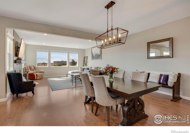 dining area with recessed lighting, wood finished floors, and baseboards