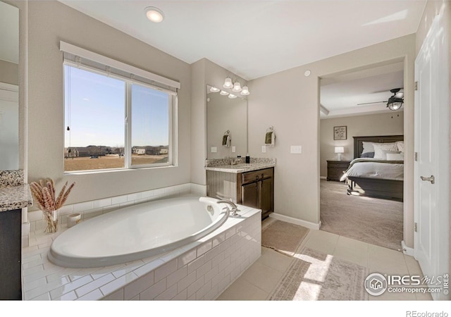 ensuite bathroom with vanity, ceiling fan, ensuite bathroom, tile patterned floors, and a bath