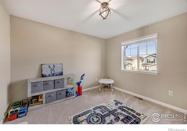 playroom with carpet, visible vents, and baseboards