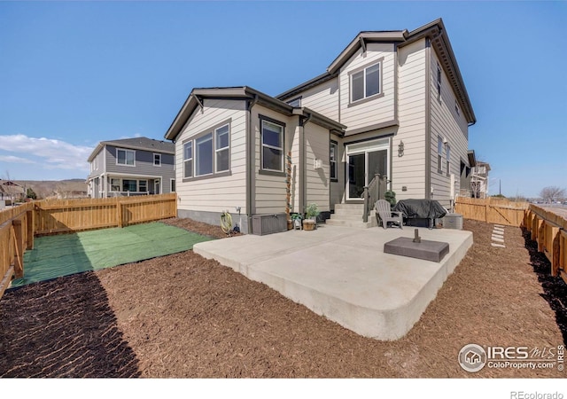 rear view of house with a patio, a fenced backyard, and entry steps