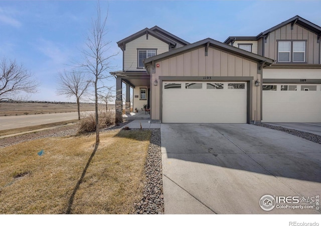 view of front of home with board and batten siding, driveway, and a garage