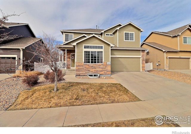 craftsman inspired home with an attached garage and driveway