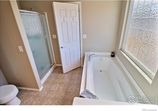 full bathroom featuring a garden tub, toilet, a shower stall, and tile patterned flooring