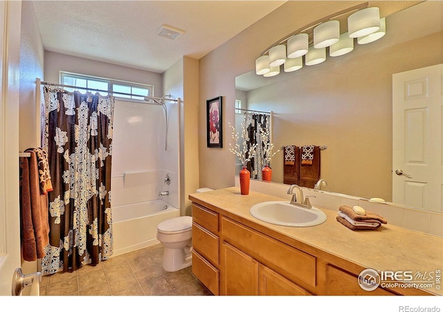 full bathroom with tile patterned flooring, visible vents, toilet, shower / bath combo with shower curtain, and vanity