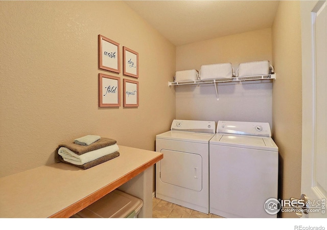 clothes washing area featuring laundry area and washing machine and clothes dryer