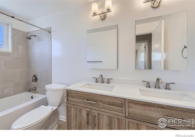 full bathroom with a sink, shower / bath combination, toilet, and double vanity