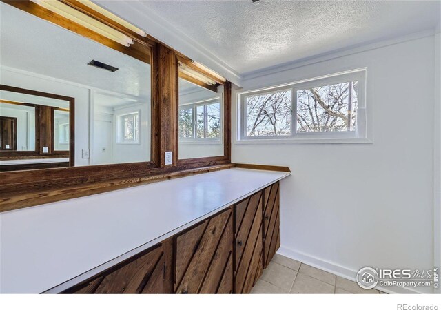 bathroom featuring a textured ceiling, vanity, and tile patterned flooring