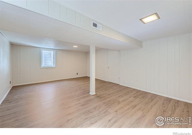 basement with wood finished floors and visible vents