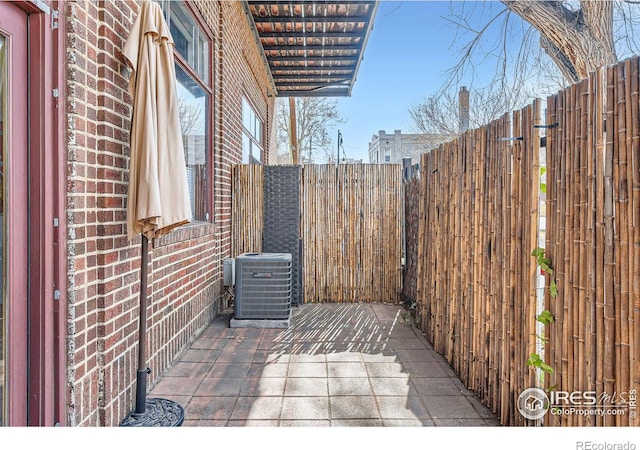 view of patio featuring central air condition unit and a fenced backyard