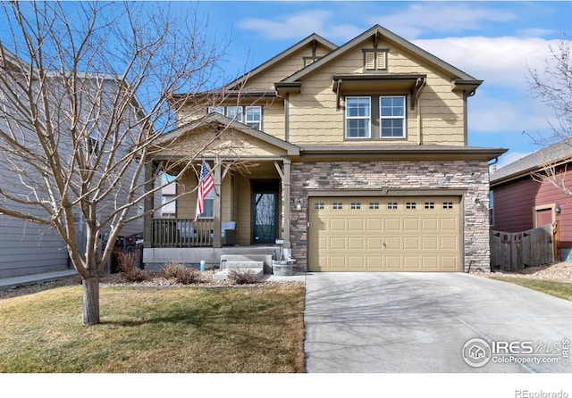 craftsman inspired home featuring a front yard, covered porch, a garage, stone siding, and driveway