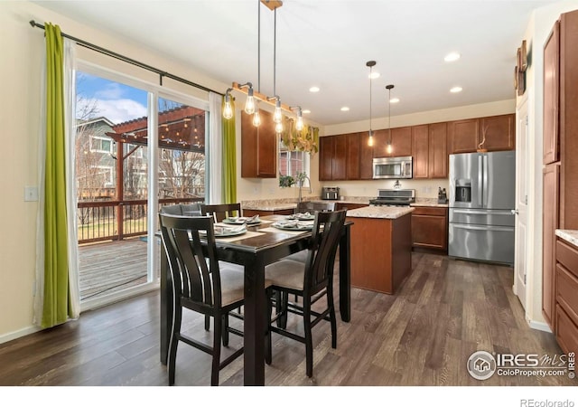 dining room featuring dark wood finished floors, recessed lighting, and baseboards